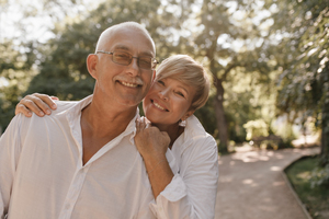 <a href="https://www.freepik.com/free-photo/smiling-old-man-with-grey-hair-mustache-glasses-light-shirt-hugging-with-blonde-woman-white-clothes-park_13214698.htm">Image by lookstudio</a> on Freepik
